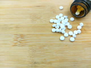 calcium pills on wooden background