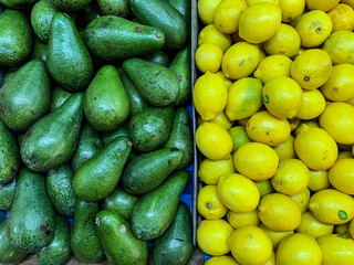 Green avocados and yellow lemons on the market. Netanya, Israel