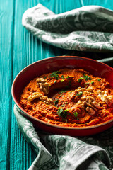 Roasted red bell pepper spread in a red bowl  with a vintage napkin