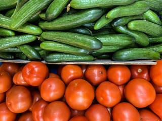 Green cucumbers and red tomatoes on the market. Netanya, Israel