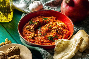  Roasted red bell pepper spread in a red bowl  with various ingredients