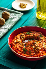  Roasted red bell pepper spread in a red bowl  with various ingredients