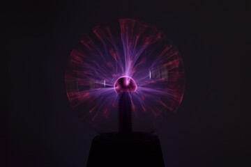 A closeup shot of a colorful plasma ball on a black background