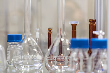 New Glass ware flasks. Equipment for the chemical laboratory. stand on the glass table.