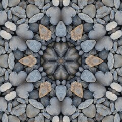 kaleidoscopic style of pebbles on a beach with colourful child's play fork and rake