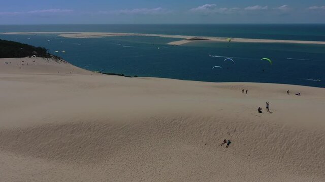  Paragliders fly over the Dune of Pilat ( Dune du Pilat ), Arcachon, France. Largest sand dune in Europe.