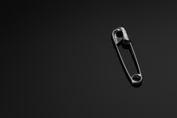 safety pin isolated on black