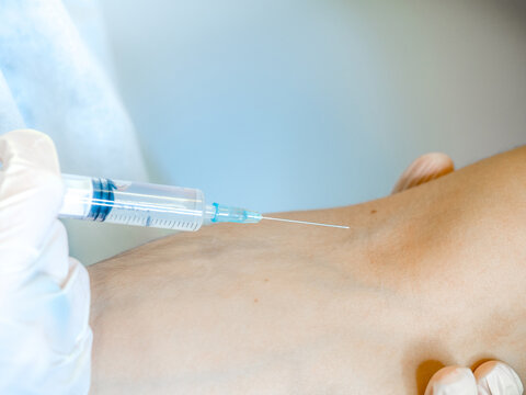nurse with siringe in hand for vaccine