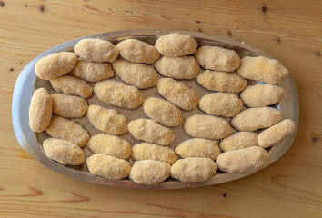 Homemade chiken croquettes prepared in a metal tray