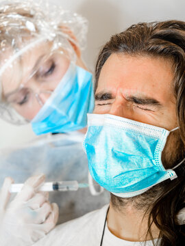 Nurse vaccinating a young patiente