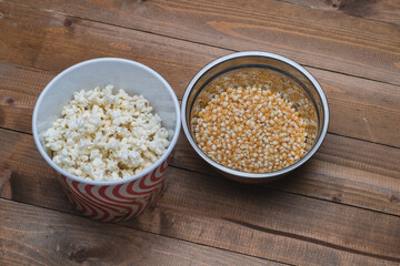 popcorn and corn seeds on wooden background 