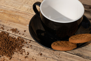 close up morning instant coffee with two biscuit cookies on a wooden table
