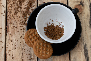 close up morning instant coffee with two biscuit cookies on a wooden table