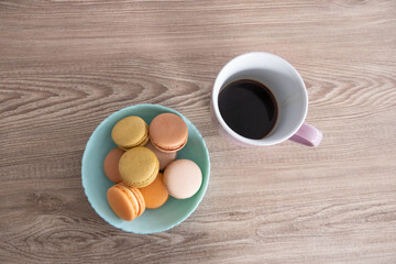 Sweet French Macarons in different colors with a Pink Coffee Mug