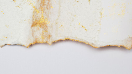 Torn piece of edge paper on white background. Gold and bronze color marble texture.