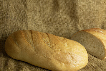 Fresh handmade bread on sackcloth background