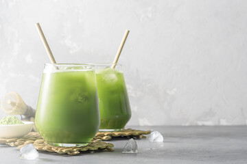 Refreshing cocktail of iced tea matcha on a concrete background with copy space.