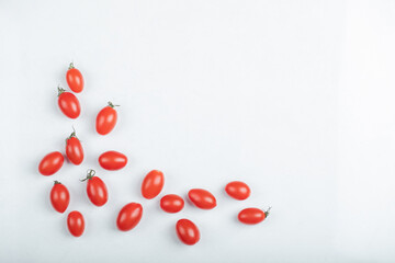 Organic cherry tomatoes on white background