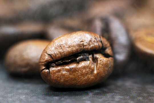 Closeup of coffee bean on black background, macro