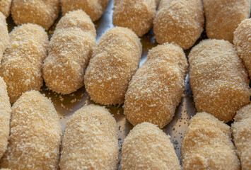 Homemade chiken croquettes prepared in a metal tray