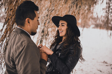 Mexican man holds the hands of a Ukrainian woman