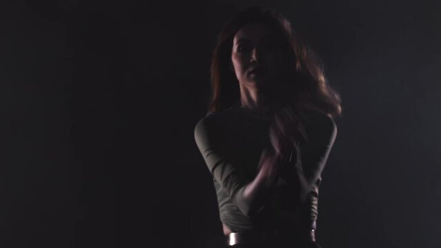 Vogue dance - young attractive woman dances in the dark room