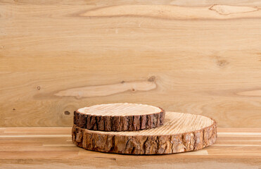 Two pine tree wood discs stacked as a podium for products, natural wood board background with lot...