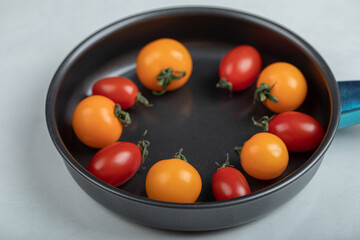 Close up photo of Colorful fresh cherry tomatoes in the pan on white background