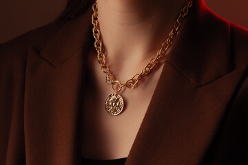 Cropped close up portrait of young woman with perfect silky skin, demonstrating golden jewelry...