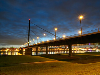 Oberkasseler Bridge over the river Rhine in the German city of Dusseldorf in the early morning. Blue hour.