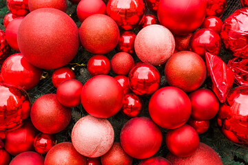 Red Christmas balls of different sizes on the Christmas tree close-up.Christmas decor
