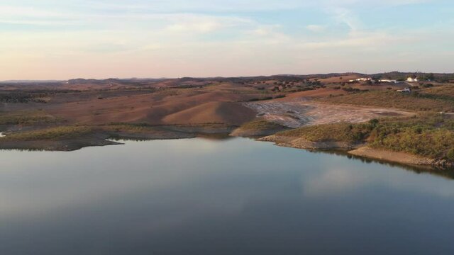 Drone aerial panorama of a desert like hill landscape with marble stones dust at sunset in Terena, Portugal