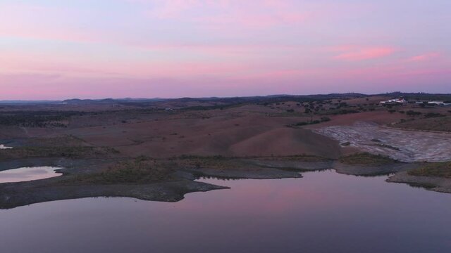 Drone aerial panorama of a desert like hill landscape with marble stones dust at sunset in Terena, Portugal