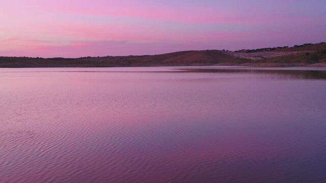 Drone aerial panorama of a desert like hill landscape with marble stones dust at sunset in Terena, Portugal
