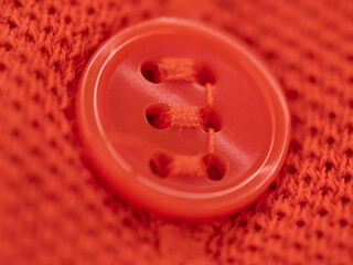 orange button on orange textured material 