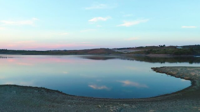 Drone aerial panorama of a desert like hill landscape with marble stones dust at sunset in Terena, Portugal