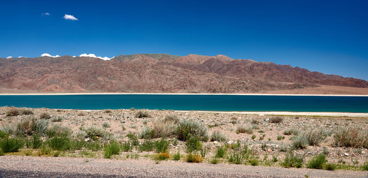 Orto Tokoy Reservoir in Kyrgyzstan with blue sky and azul water