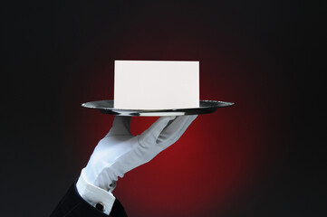 Hand Holding a Service Bell on Tray