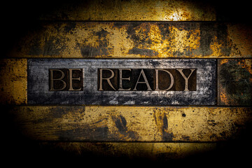 Be Ready text message on textured grunge copper and vintage gold background
