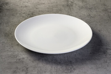 empty white dish, grey background