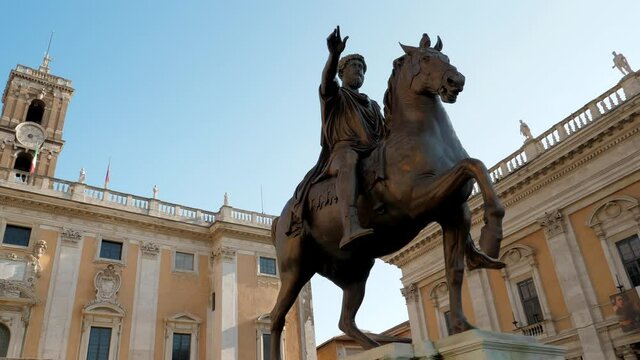 Capitoline hill and equestrian bronze statue of Marcus Aurelius surrounded by neo classic museums buildings with clock tower