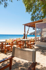Cozy beach bar in a small secret bay on the north coast of the Greek island of Crete. Nice fabric...