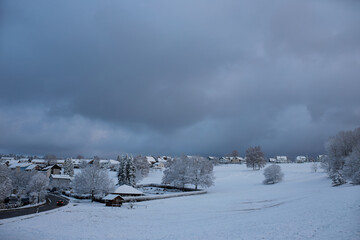 snow-covered village and cloudy sky