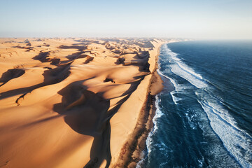 Place where Namib desert and the Atlantic ocean meets, Skeleton coast, South Africa, Namibia, aerial shot - obrazy, fototapety, plakaty
