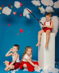 Two cute boys and a girl of angels on Valentine's Day