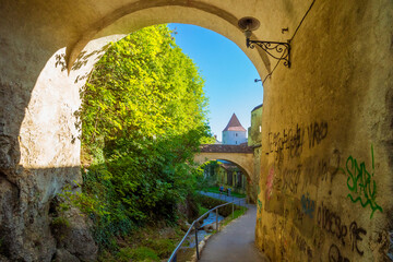 The old fortification wall surrounding the medieval town of Brasov in sunny day. Strada dupa ziduri, The street behind the walls, in Brasov, Romania. It is a street outside the former city walls.