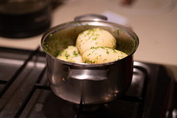 boiled potatoes in a saucepan with dill