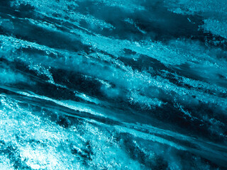 Blue ice wall texture with air bubbles