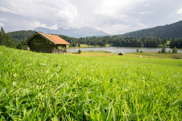 hut on meadows by Geroldsee lake, Bavarian Alps, Germany