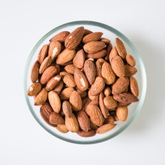 Almond in a transparent bowl on a white background